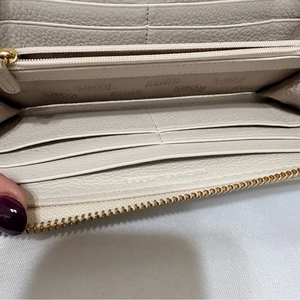 Michael Kors Moxley continental zip-around wallet in vanilla or cream leather.